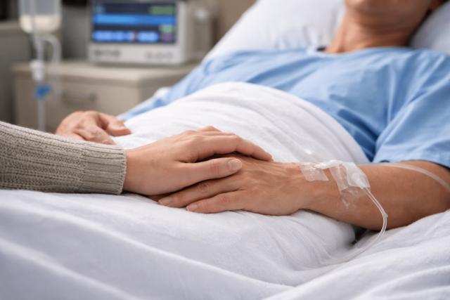 family member comforting loved one recovering hospital bed