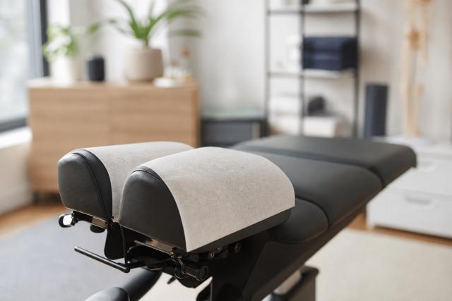 Chiropractic Adjustment Table In Empty Treatment Room